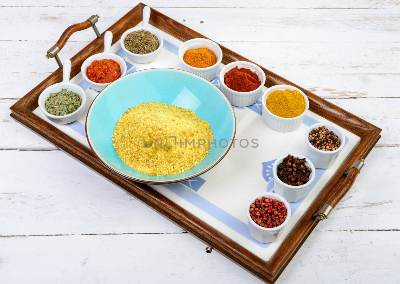 Indian spices assortments on a tray on the white wood en table