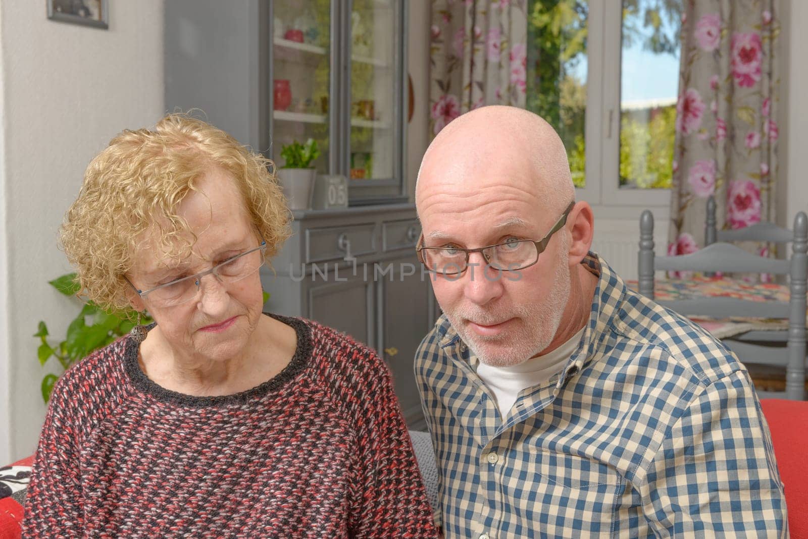 portraits of the mother and her adult son in his home