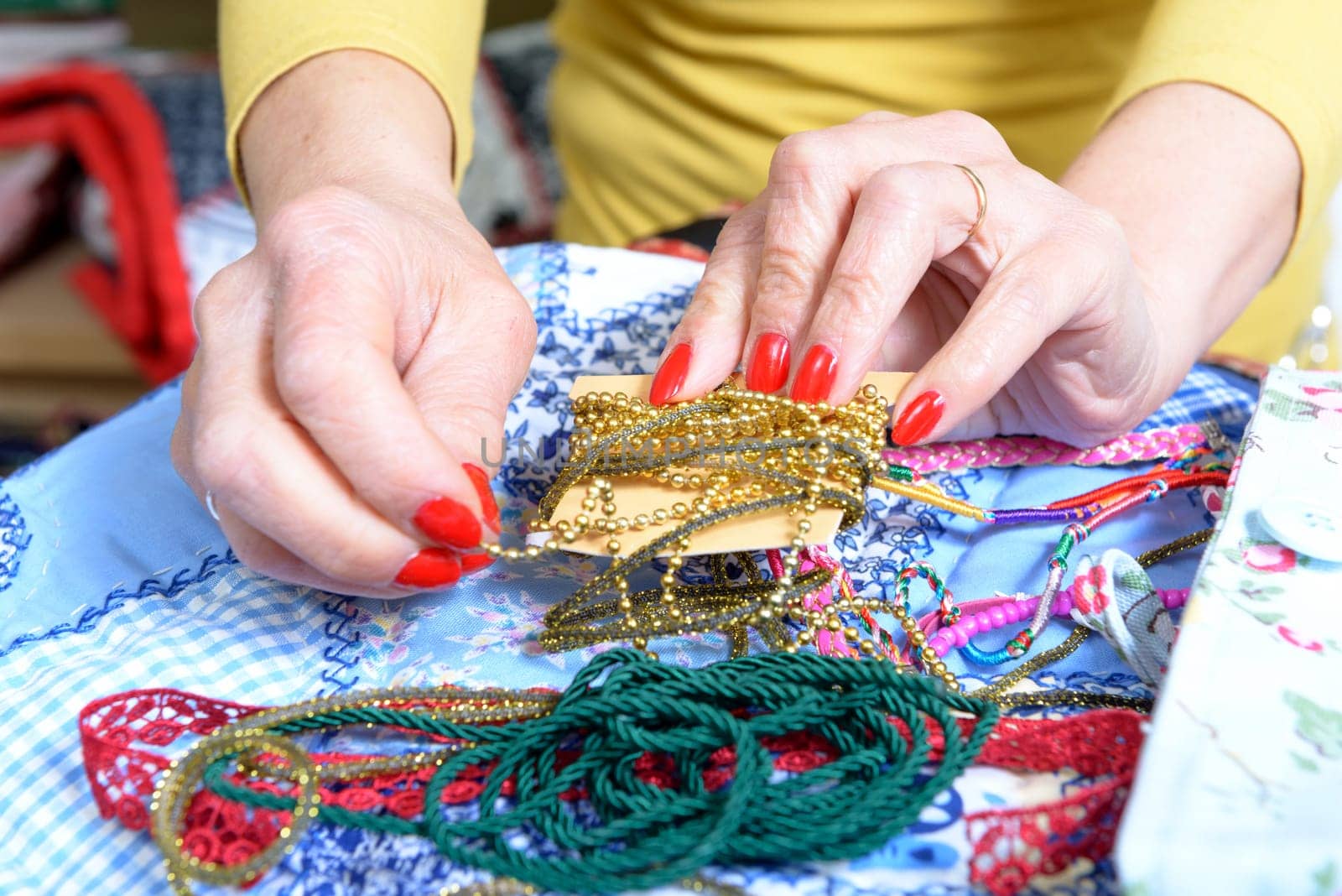close-up of the hands of a seamstress in her office