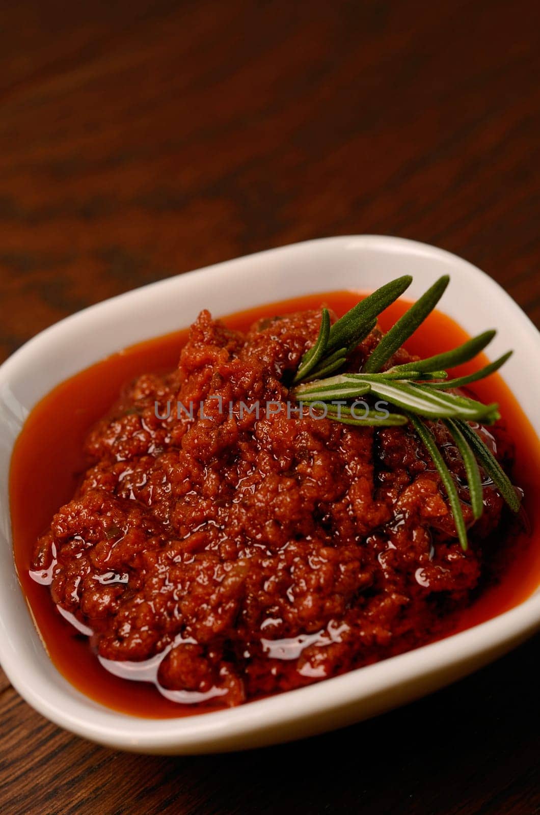 Red pesto with a twig of rosemary