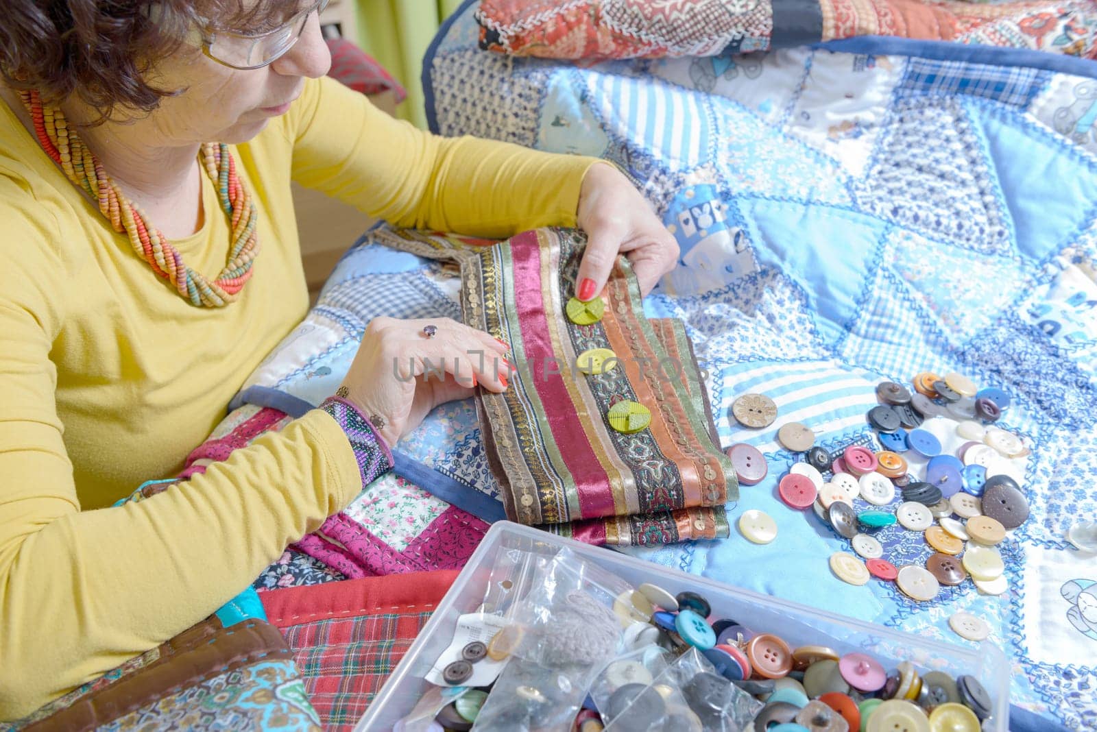 dressmaker working on her quilt in his workshop