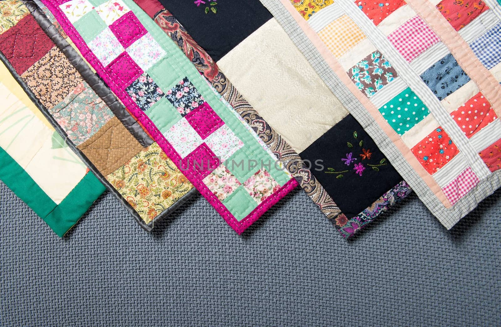 a patchwork  with different colored patterns  on grey background