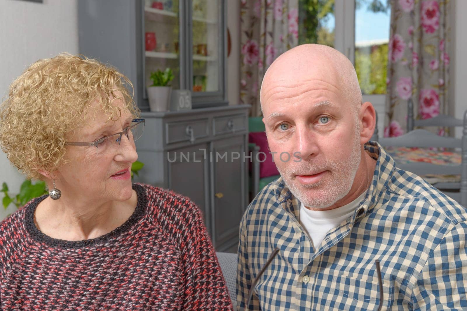 portraits of the mother and her adult son in his home