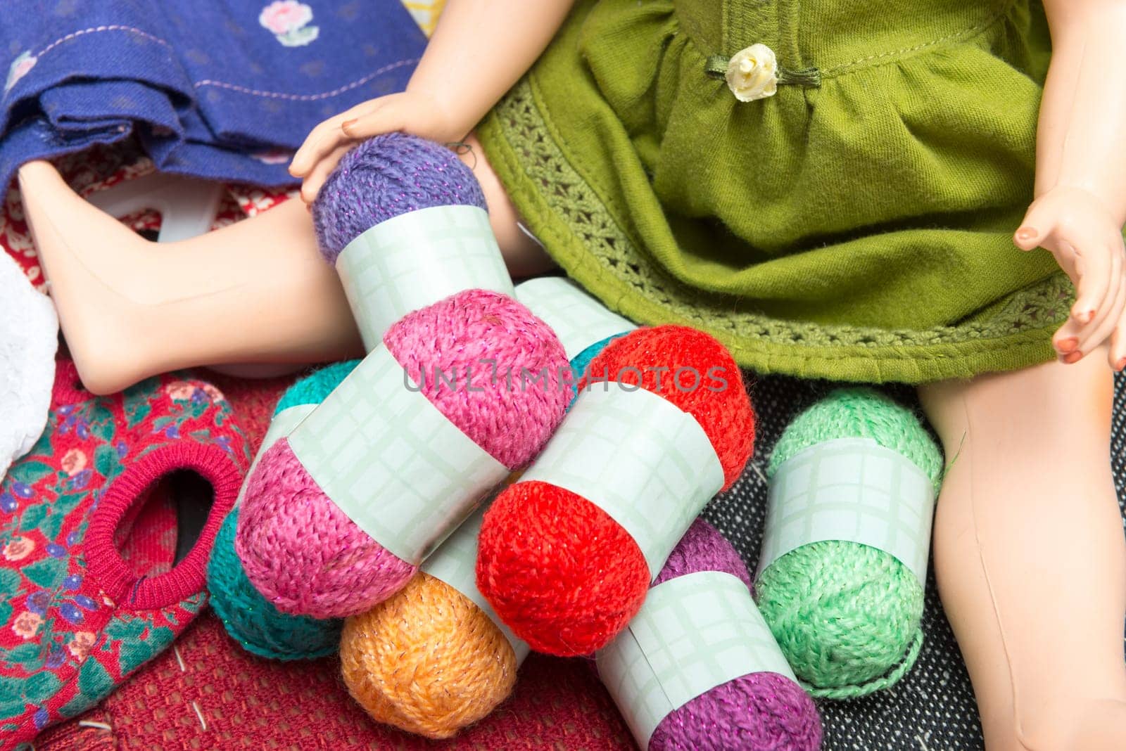 small multicolored balls of yarn with a  doll