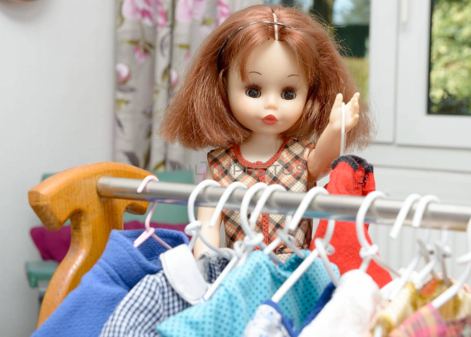 doll with red hair and several dresses