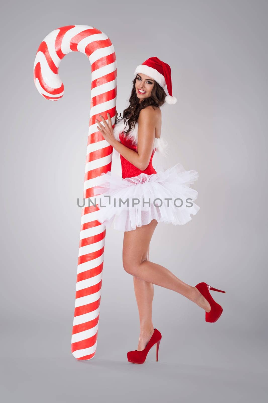 Sweet and sexy santa claus with christmas candy cane
