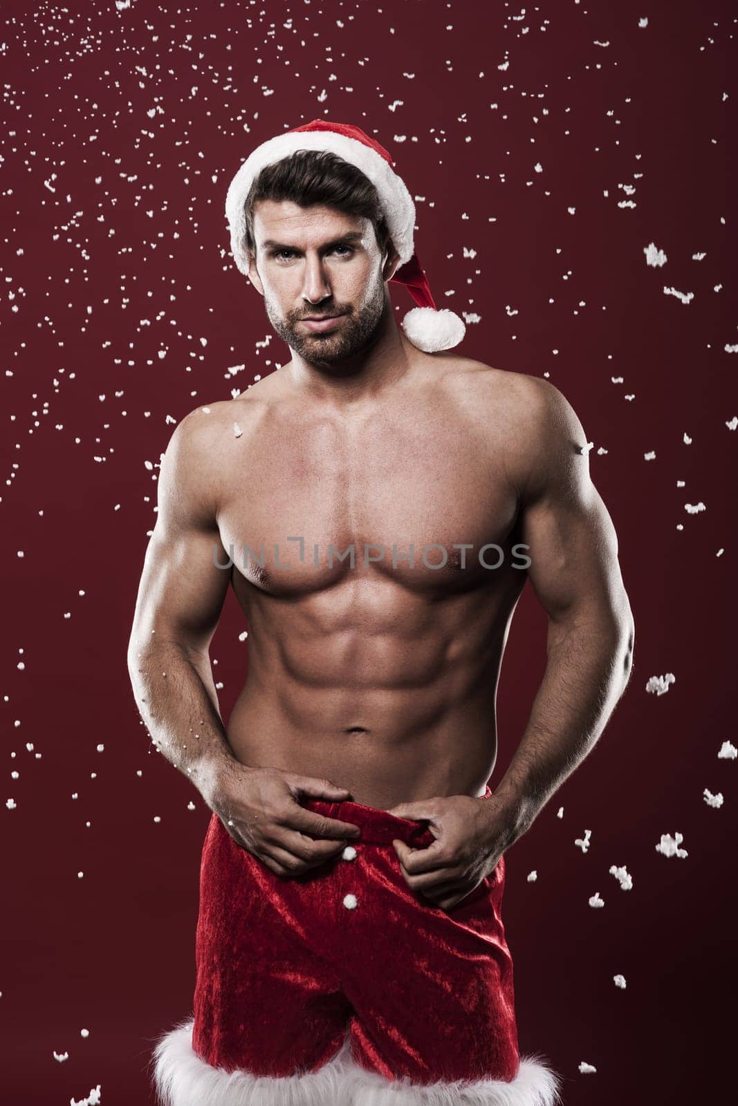 Sexy man wearing santa claus clothes