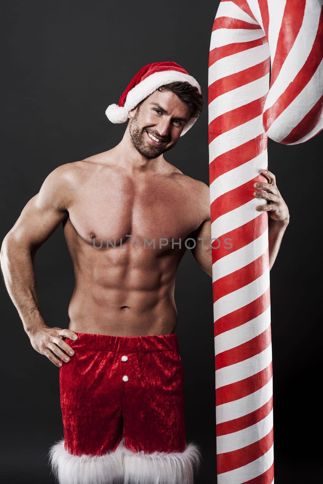 Delicious christmas candy cane with sexy man