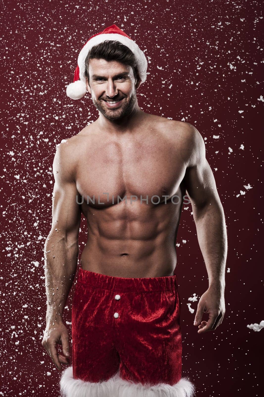 Handsome and shirtless santa claus