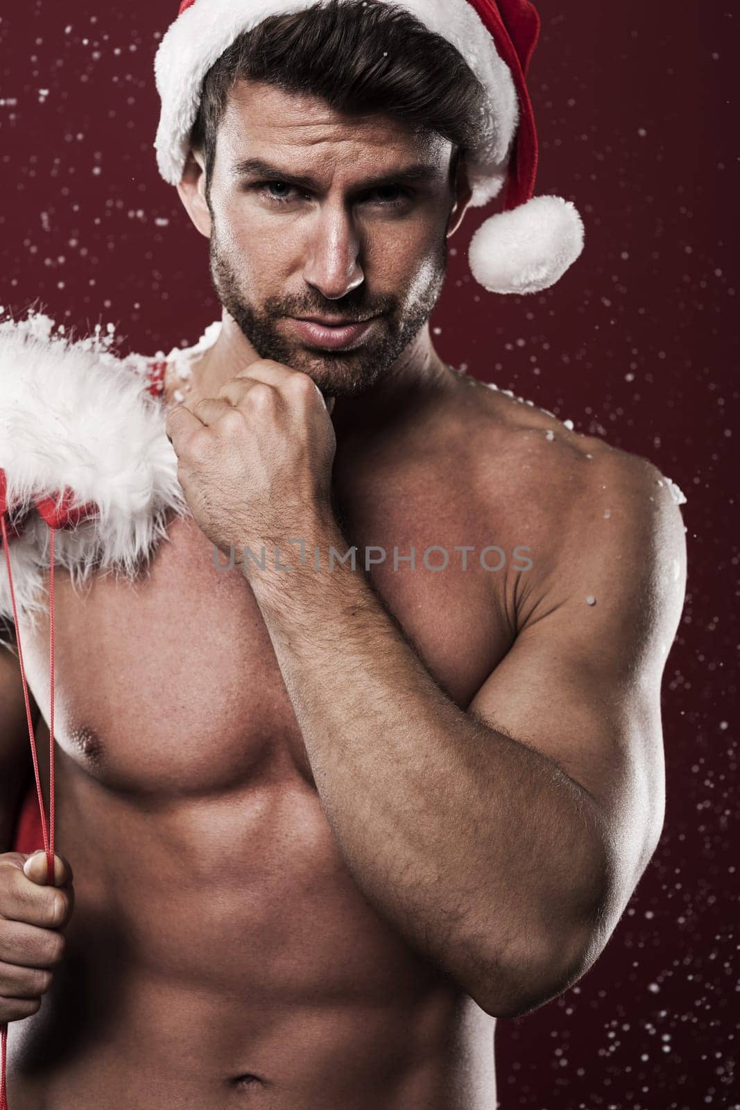 Sexy man wearing hat of santa claus and christmas sack