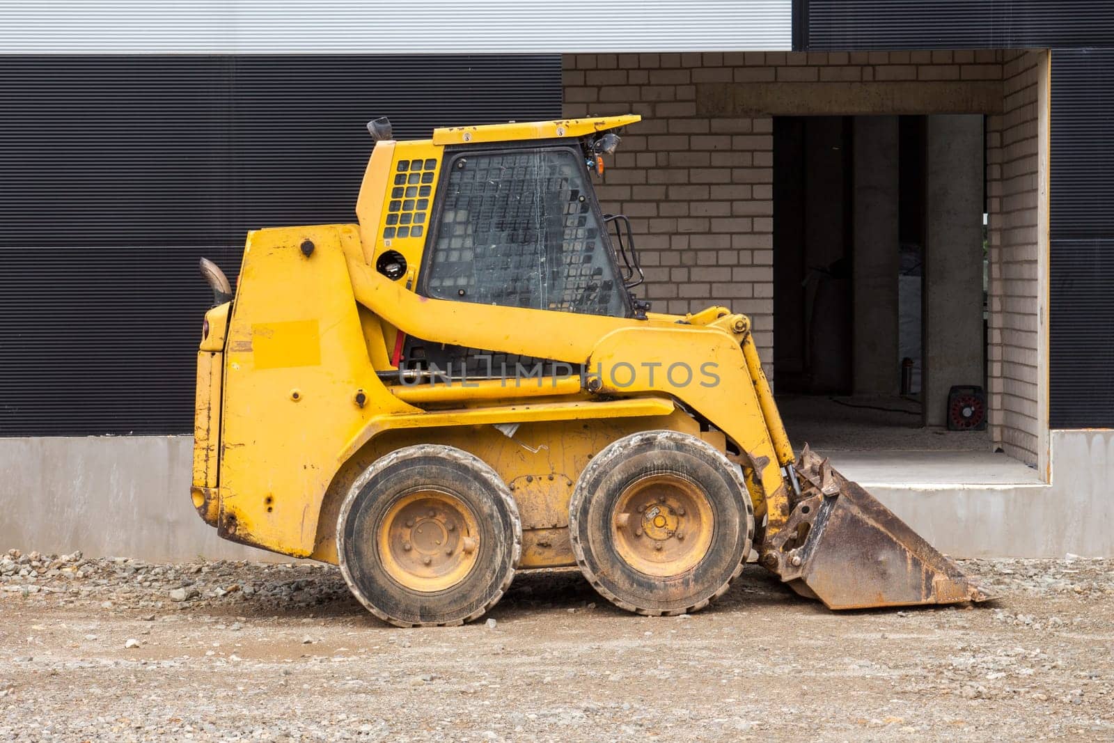 Yellow bobcat or skid loader on construction site