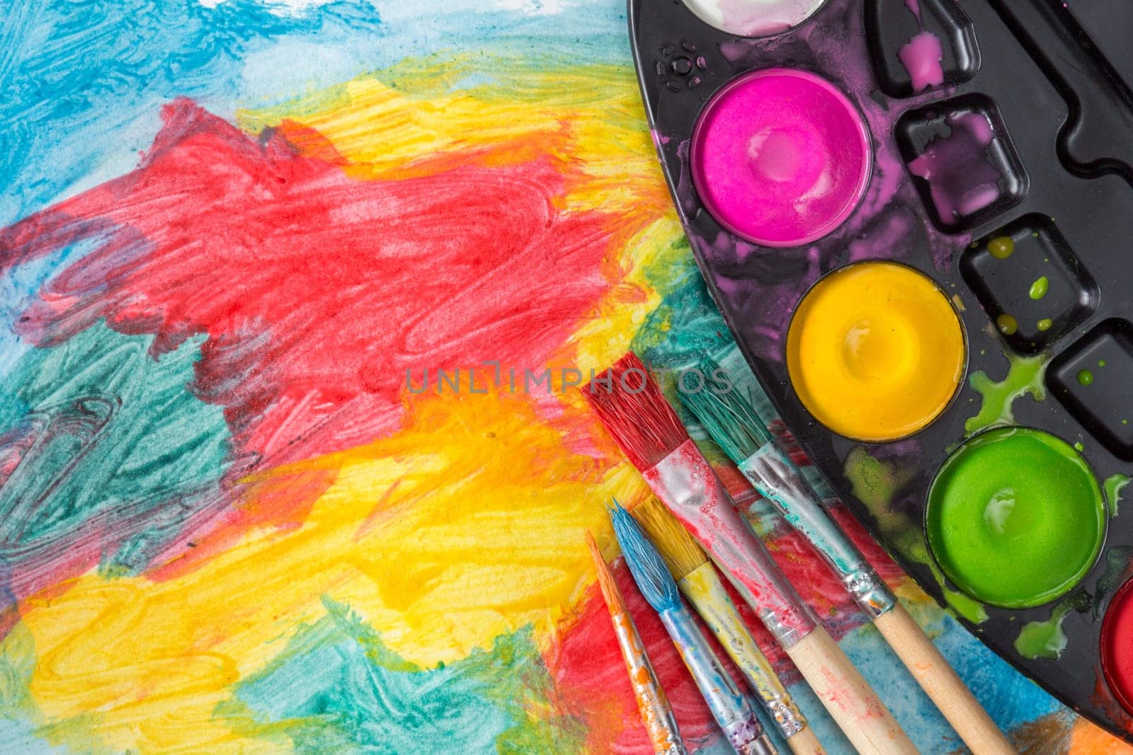 Set of watercolor paints and paintbrushes for painting closeup