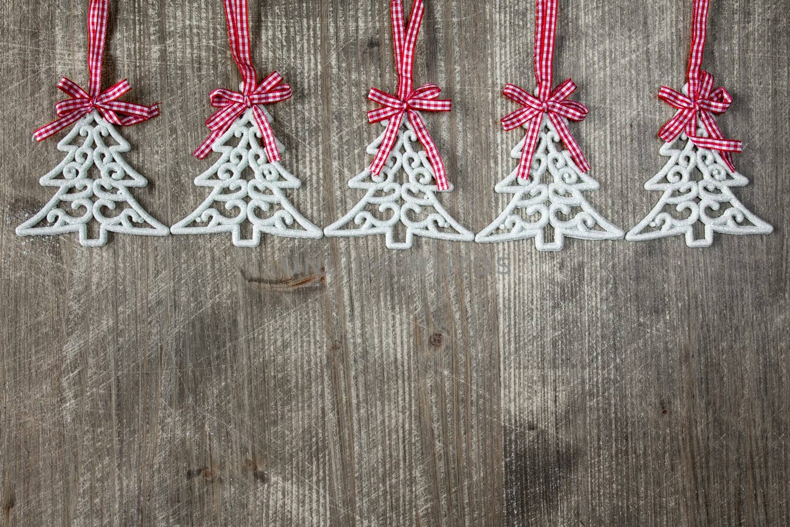 Fir tree shaped decorations on the wooden background with copy-space