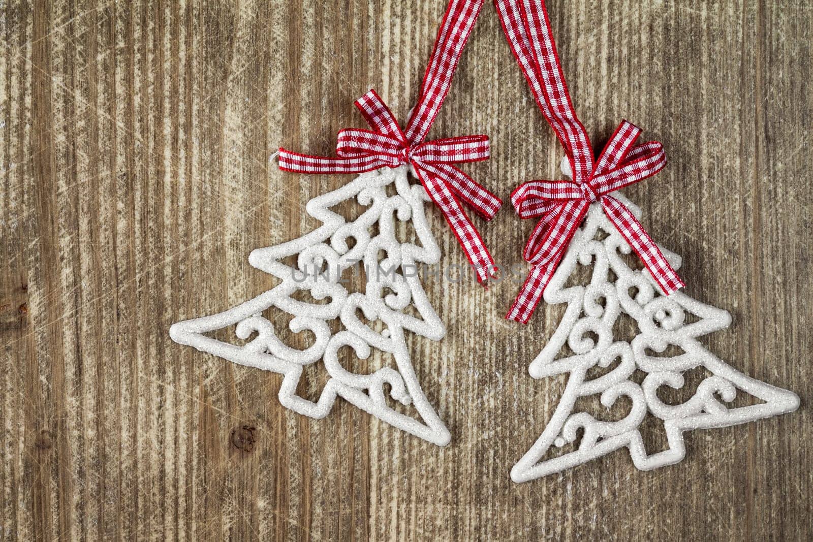Pair of christmas tree baubles on the wooden background with copy-space