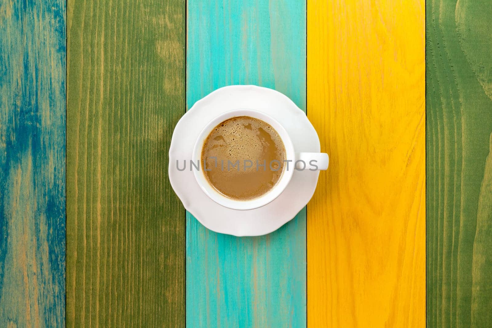 Cup of cappuccino on color table background.Top view.