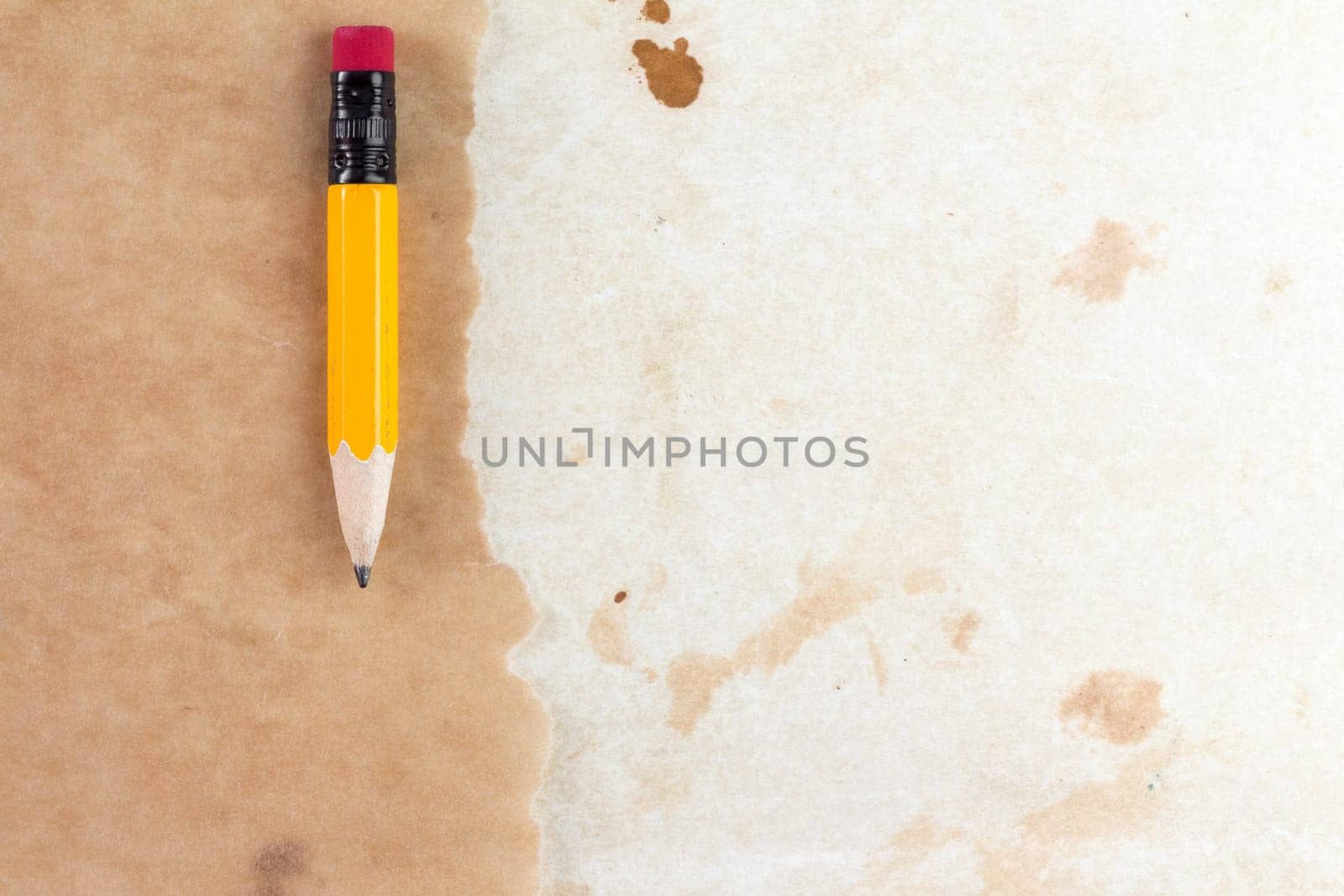 Piece of a old paper with a short pencil