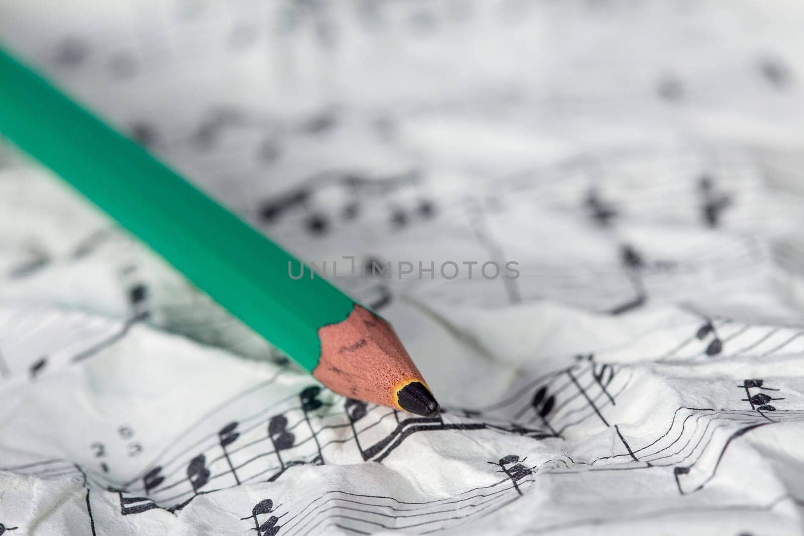 Music notes and pencil, shallow DOF