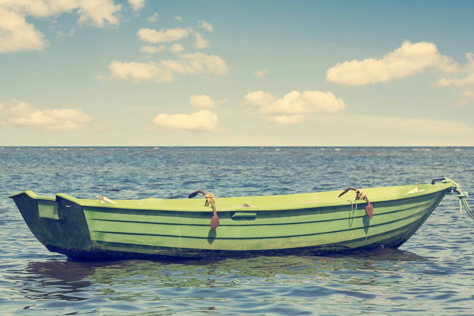 A single wooden boat floating out to sea
