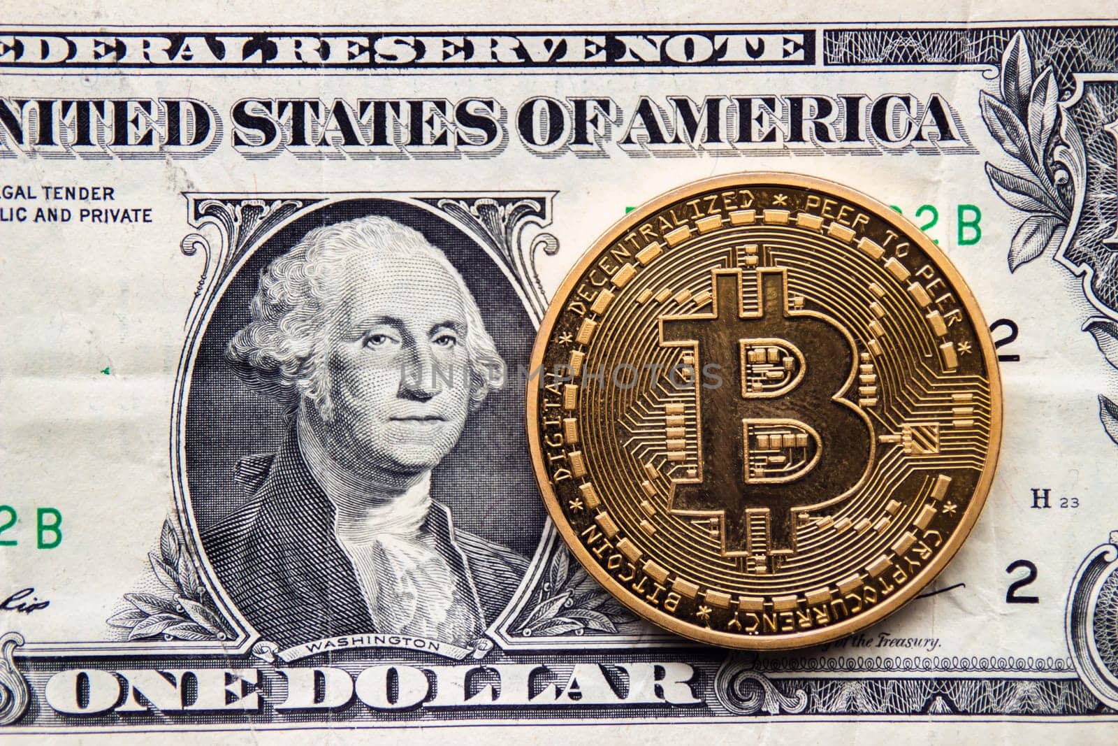 Calgary, Alberta. Canada. Jan 29, 2021. A Bitcoin coin with United States of America currency on the background