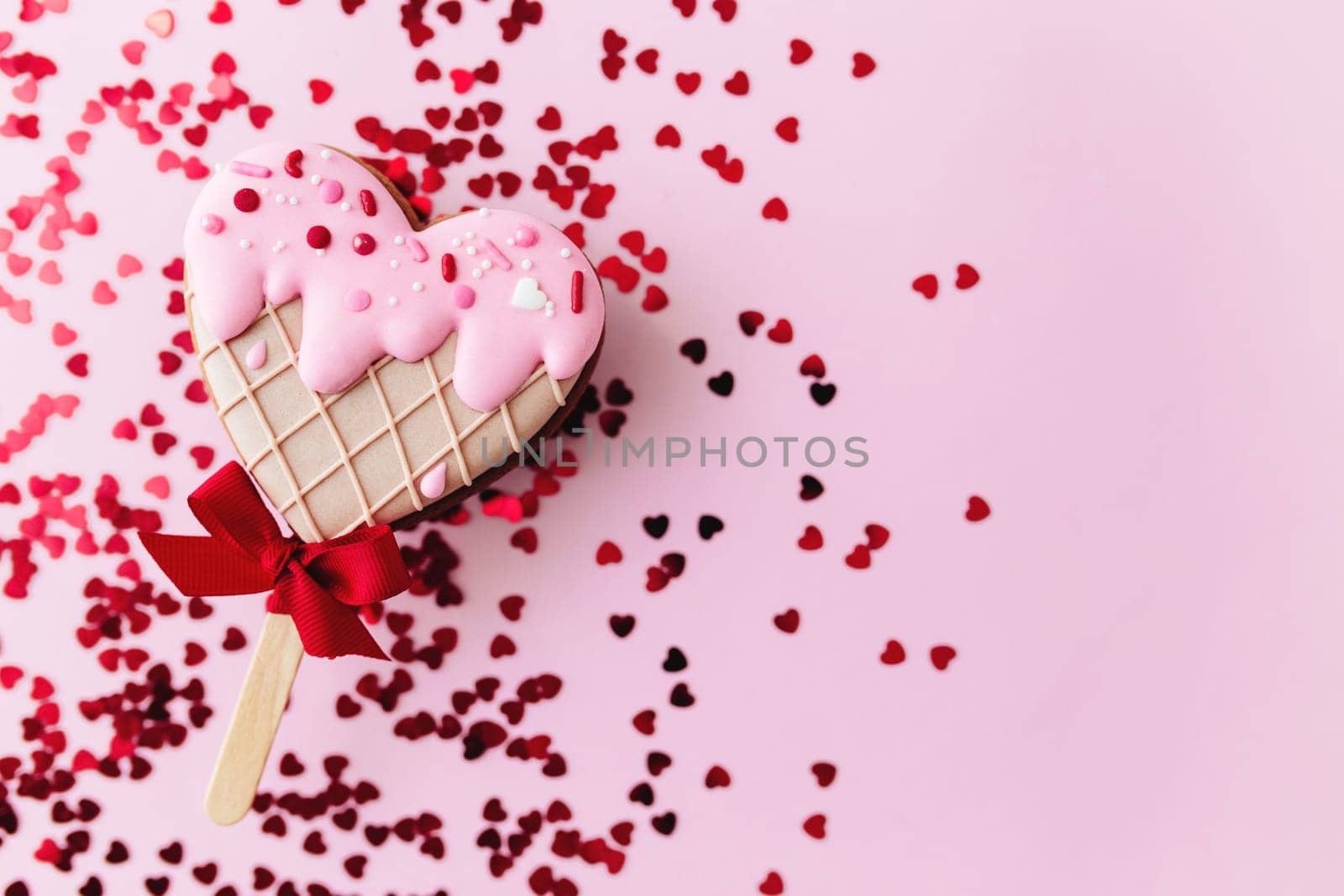 Melting ice cream heart gingerbread cookie. Valentine. Pink background, glitter. High quality photo