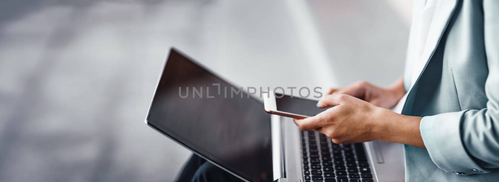 young woman with laptop sitting on the stairs. Person using personal computer outdoors