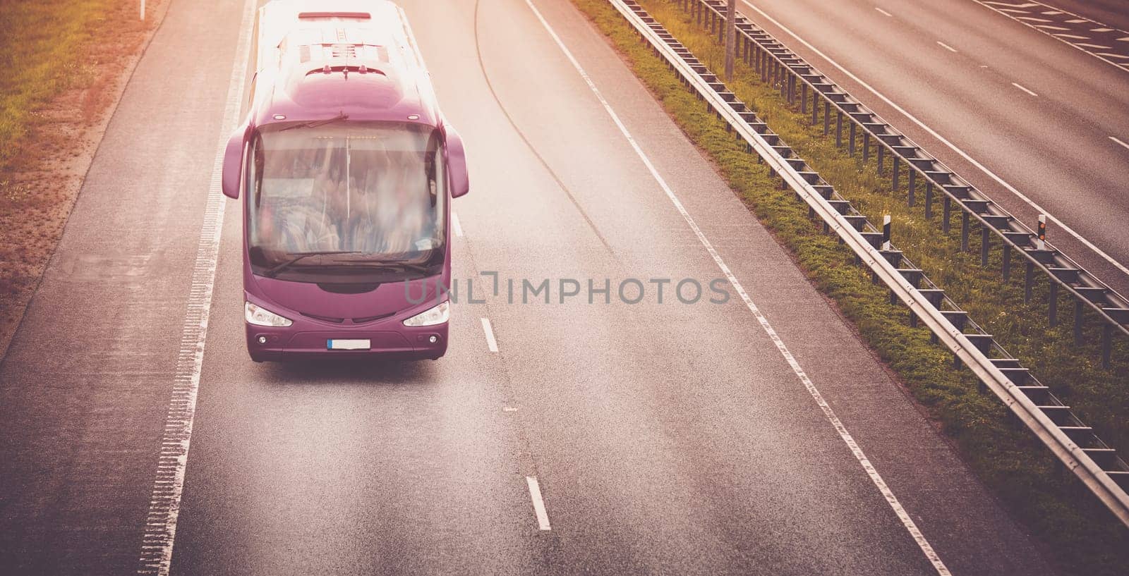 Bus on asphalt road in beautiful summer evening outdoors