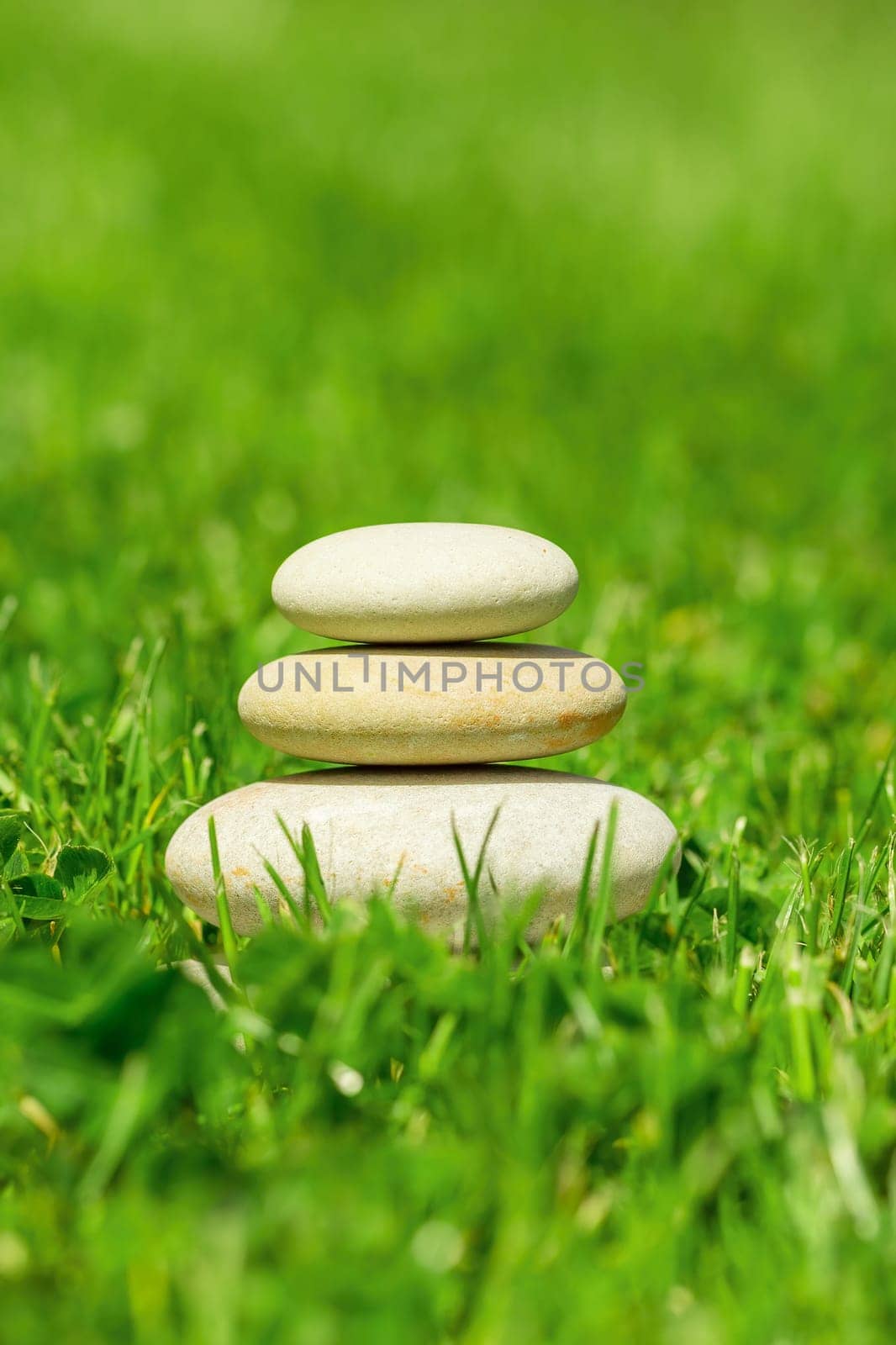 balancing pile of pebble stones, like ZEN stone, outdoor in springtime, spa wellness tranquil scene concept, soul equanimity mental calmness picture