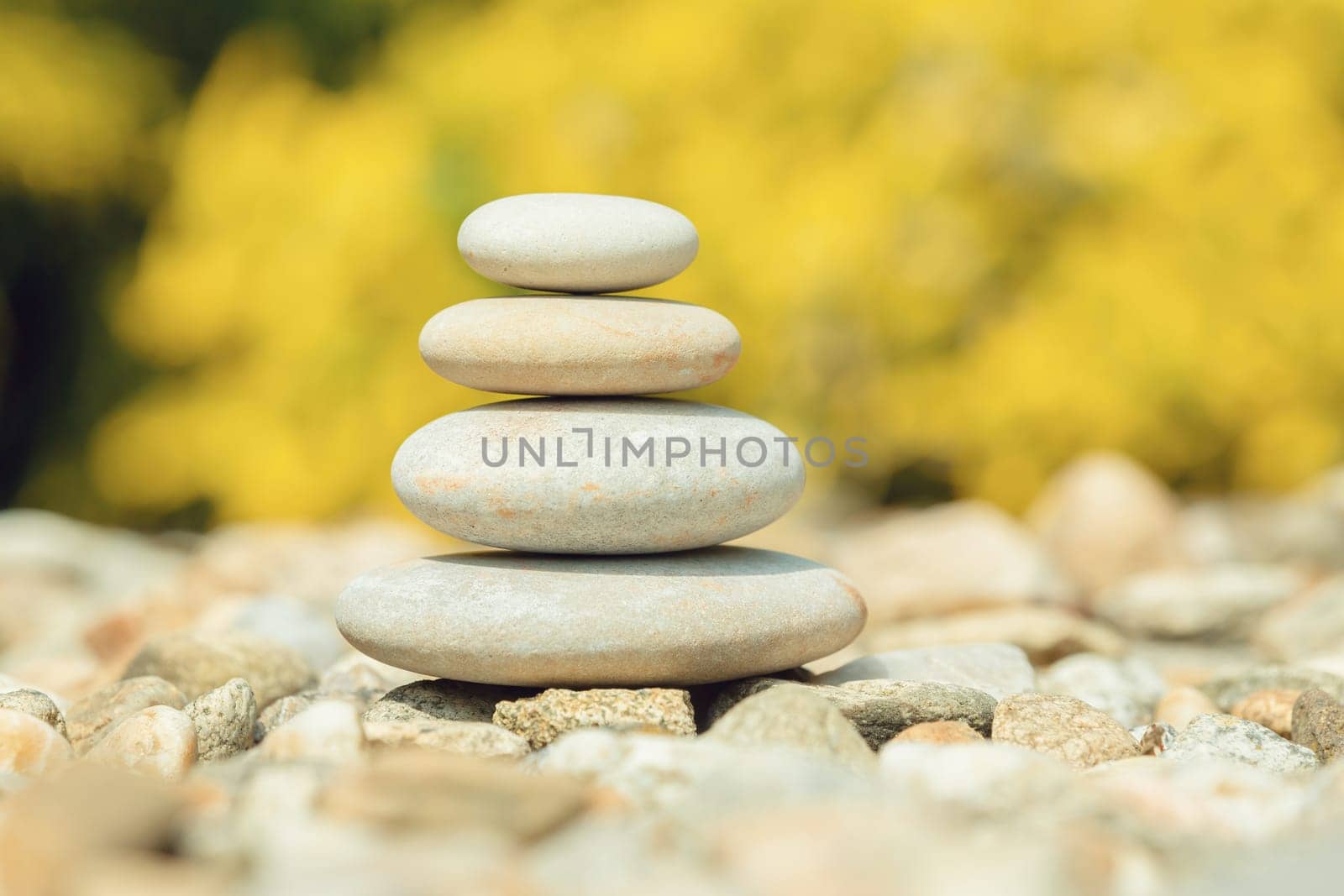 balancing pile of pebble stones, like ZEN stone, outdoor in springtime, spa wellness tranquil scene concept, soul equanimity mental calmness picture