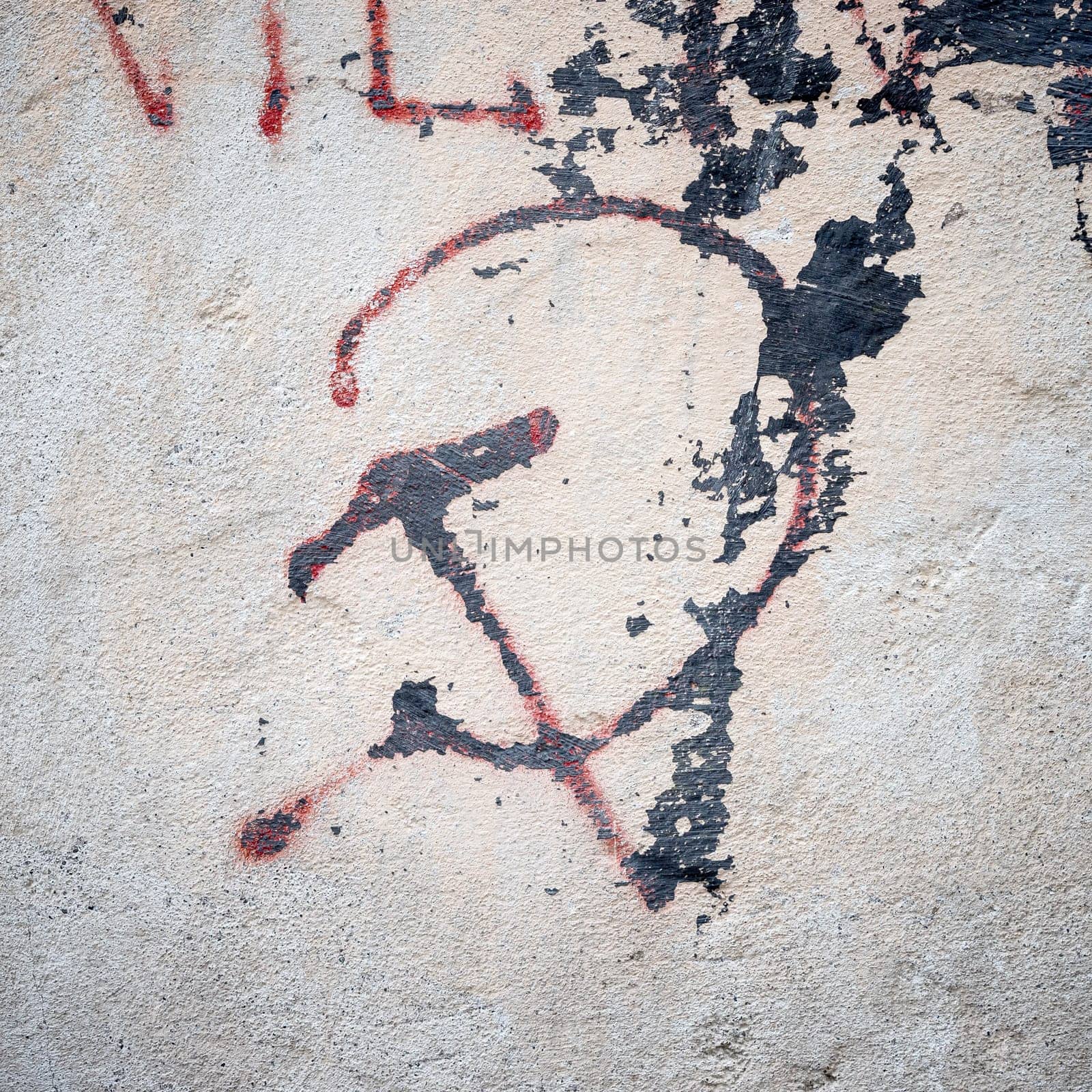 Old grungy communism symbol graffiti on a wall, red color