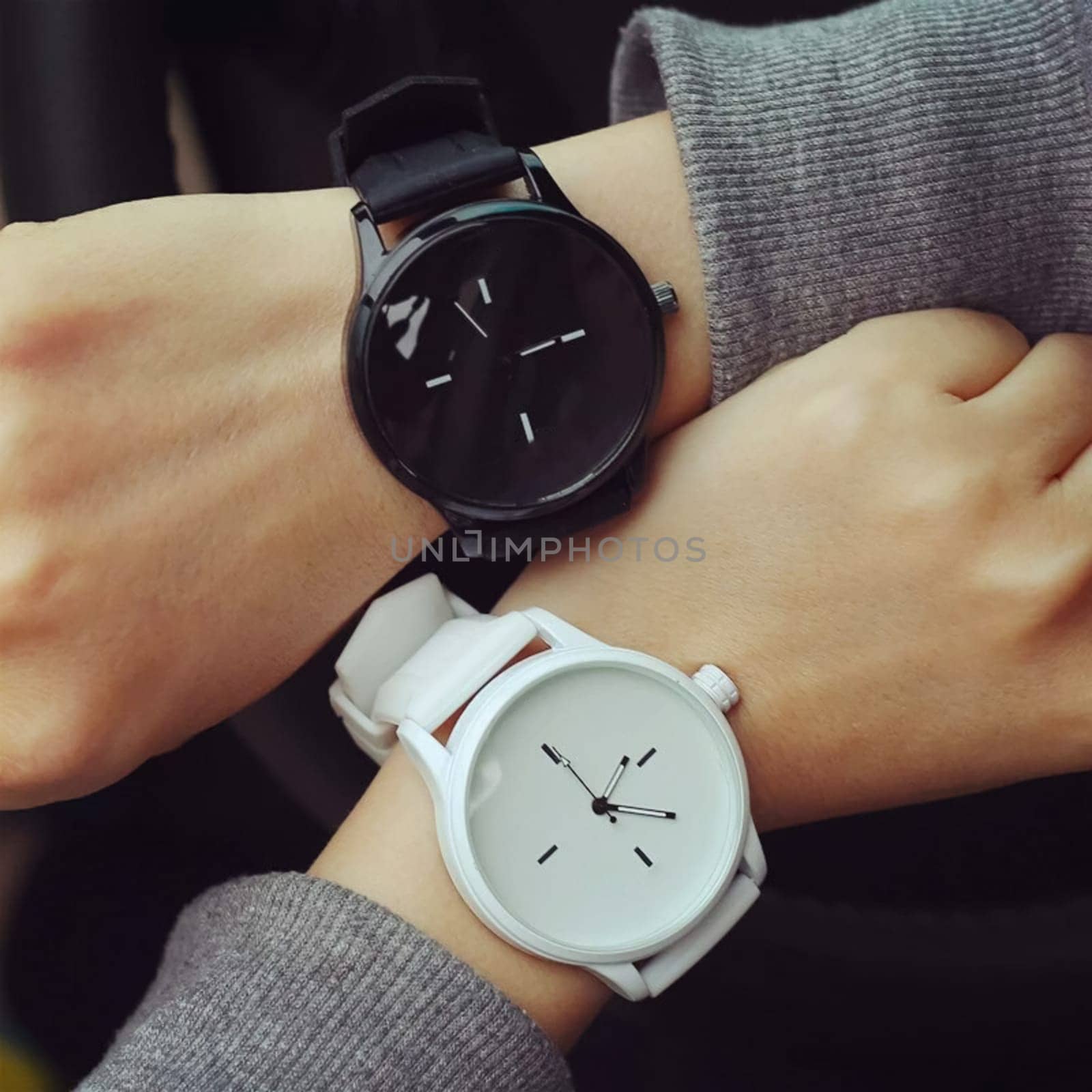 Time reconciliation on the wristwatch. White and black watches.
