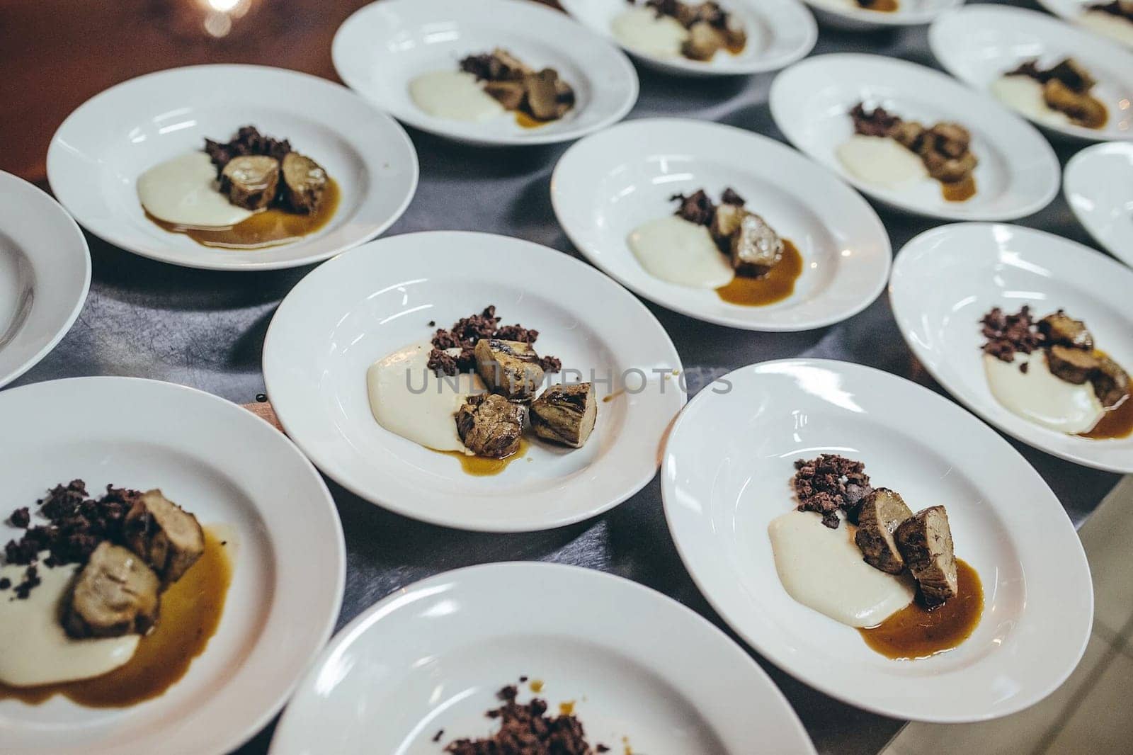 Pieces of meat with sauce and mayonnaise in plates.