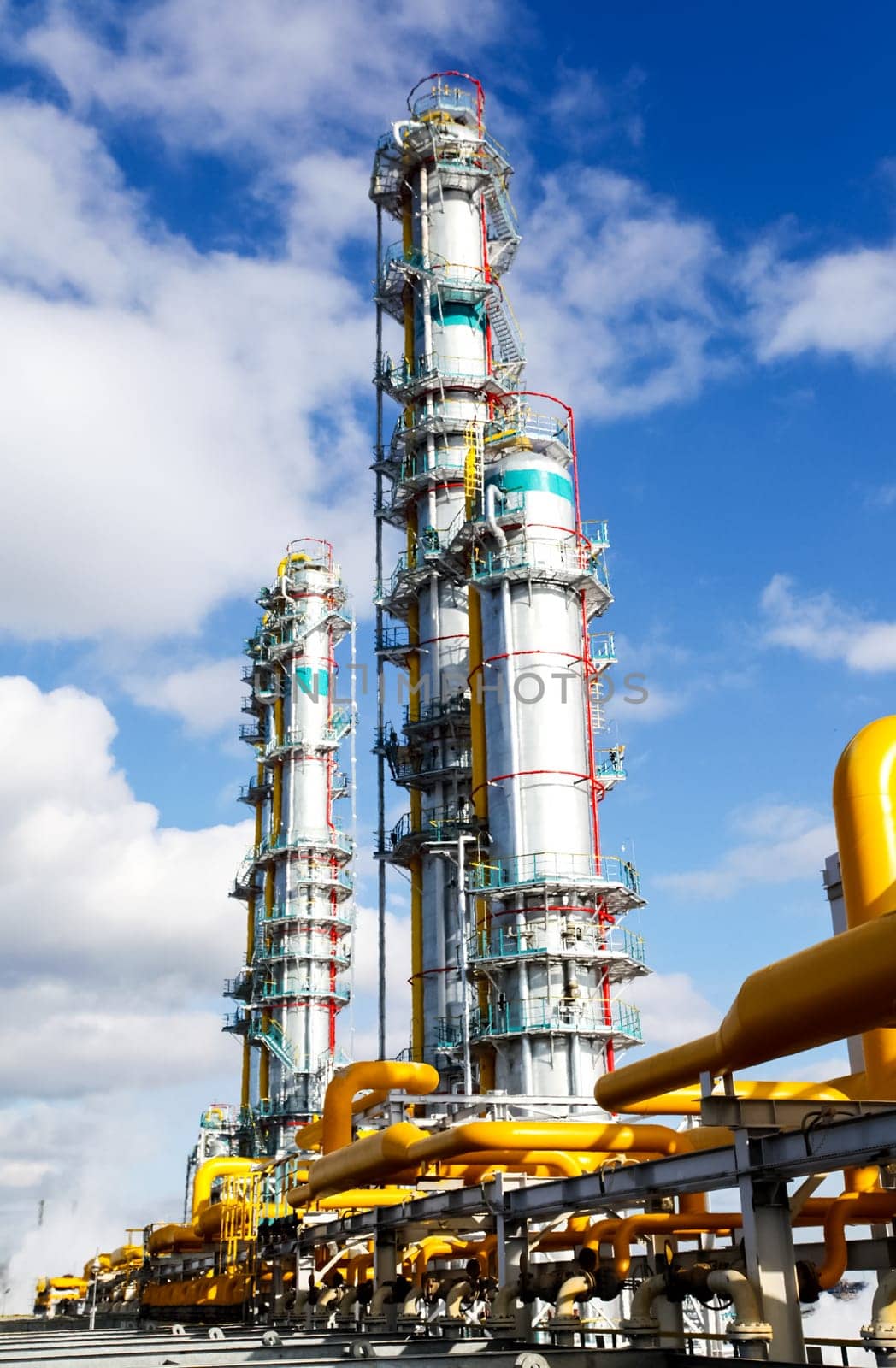 Cracking and reforming columns at a petrochemical plant Petrochemical and refinery, industrial landscape view of the plant.