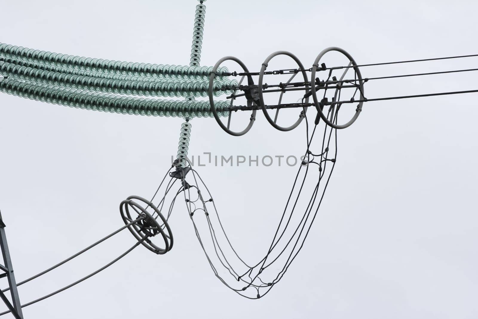 Glass insulators on high-voltage power line poles.