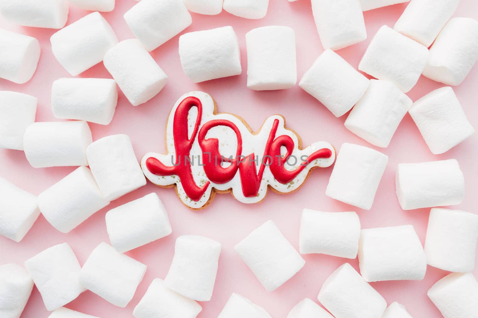 Gingerbread cookies love with white marshmallow. Valentine card. Pink background. High quality photo