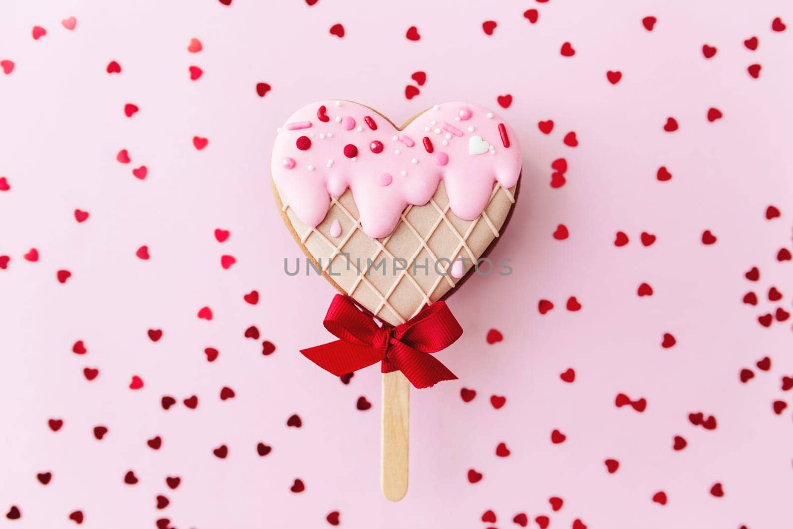 Melting ice cream heart gingerbread cookie. Valentine. Pink background, glitter. High quality photo
