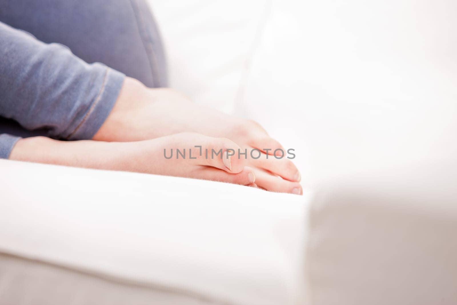 clean feet of a young woman sleeping on a white couch