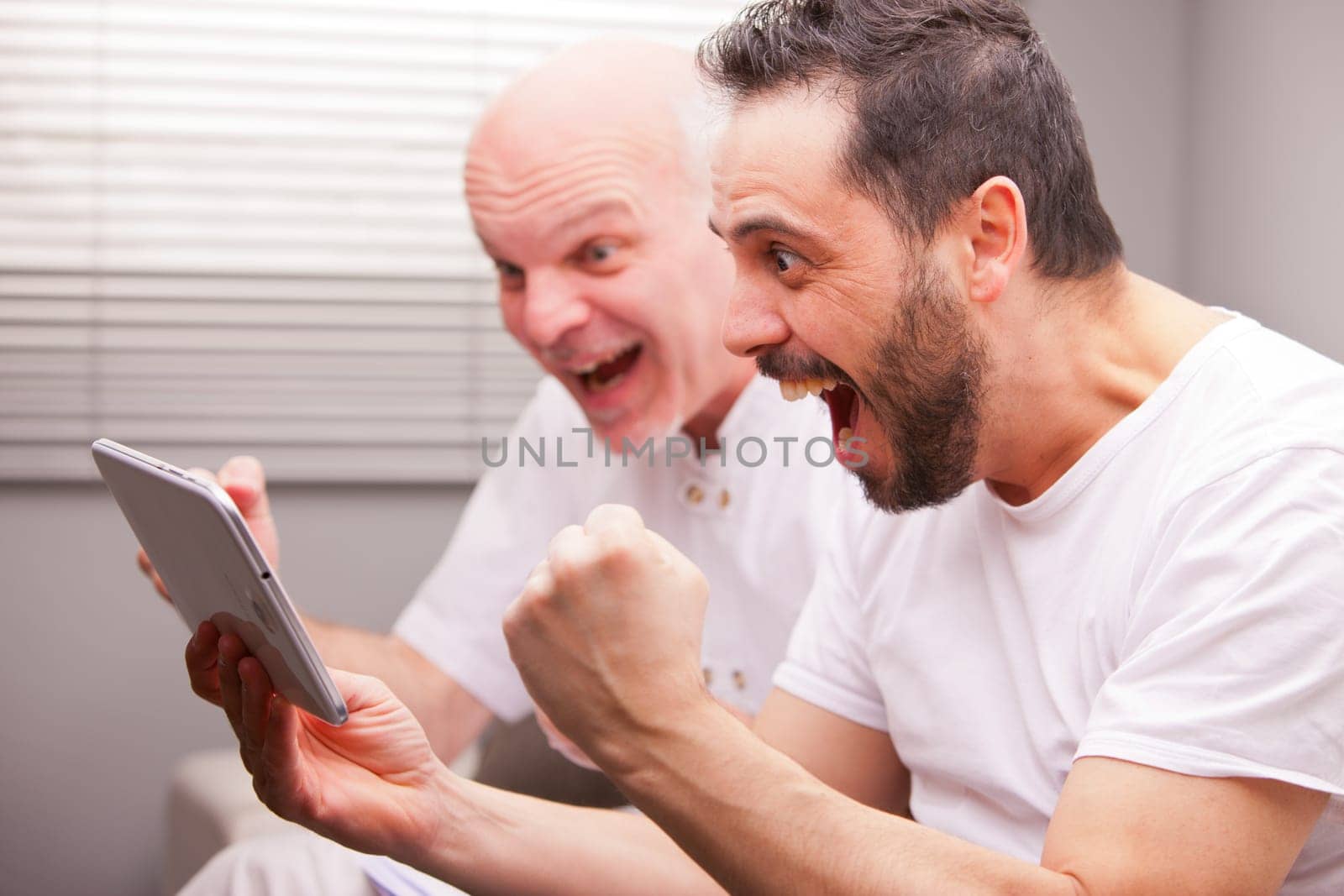 adult friends having fun like teenagers in a living room