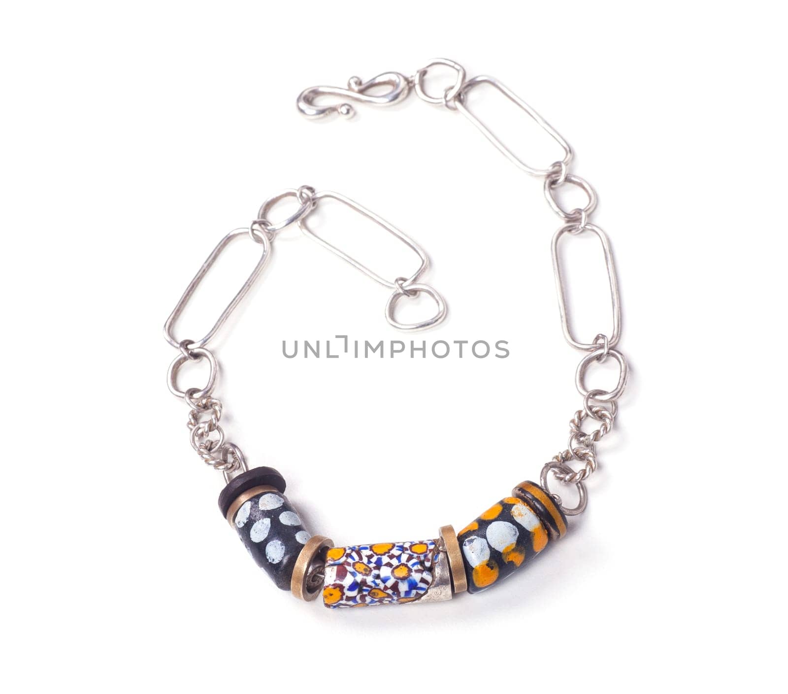 Close up of silver and painted stone necklace isolated on white background, manufactured by Ornella Salamone