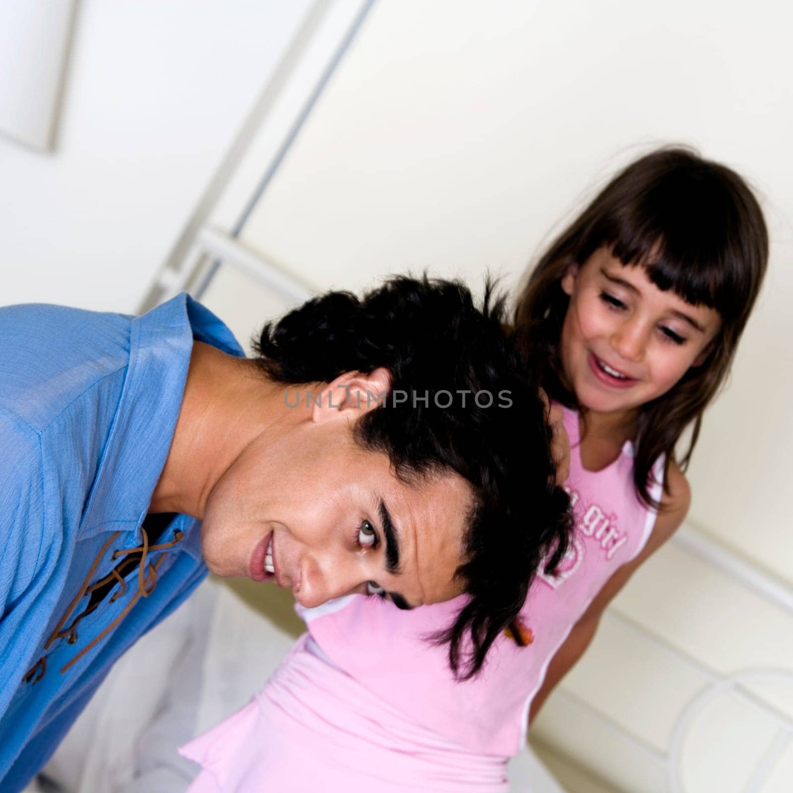 Side profile of a father and his daughter laughing by GlowImagesRF