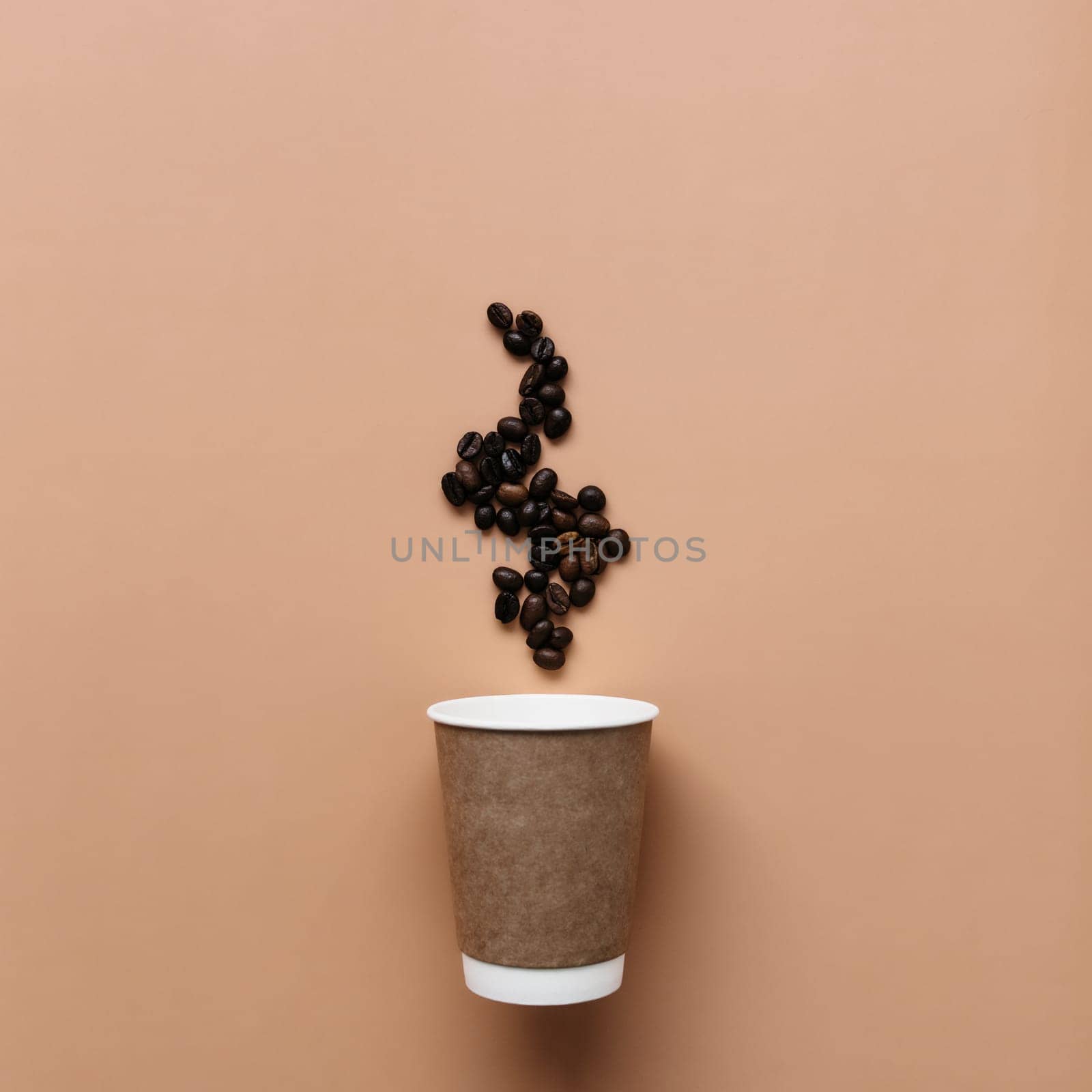 Beige background with paper coffee cup, coffee beans steam from hot coffee. High quality photo