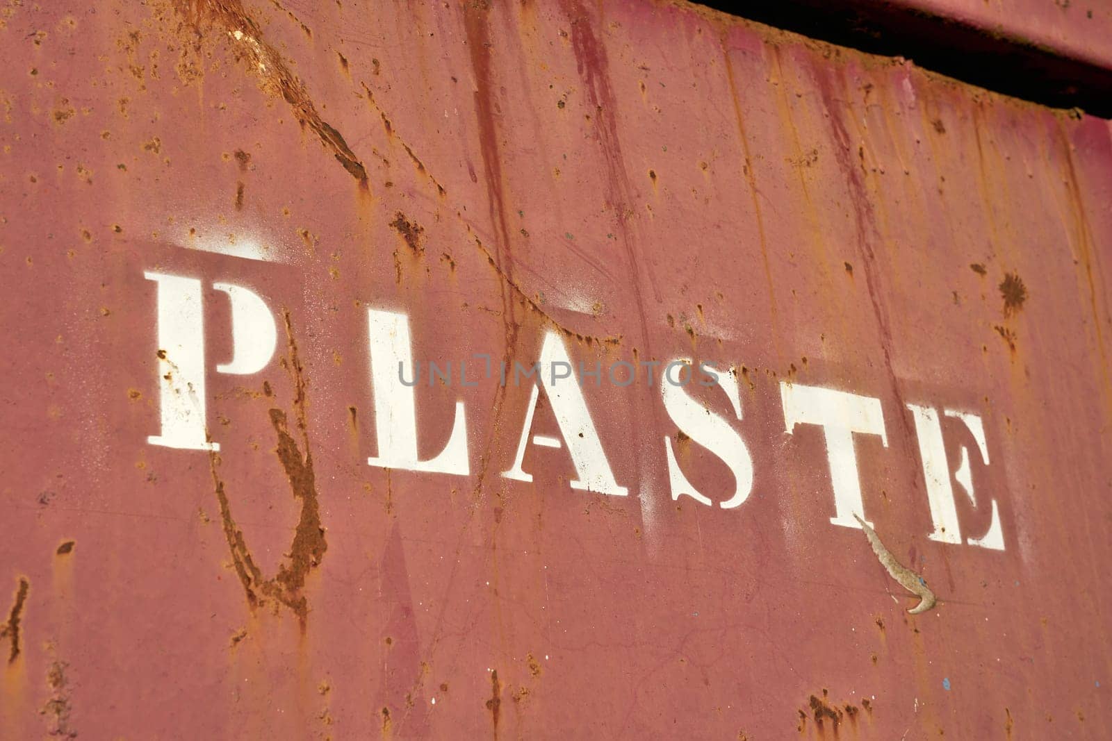 Lettering with the word Plaste (Plastic) on a container for collecting plastic waste at a disused factory in Germany