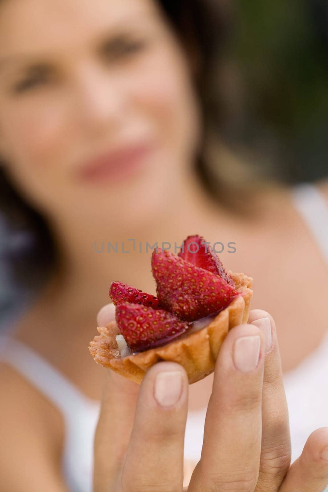 Close-up of a cupcake on a young womanŽs hand