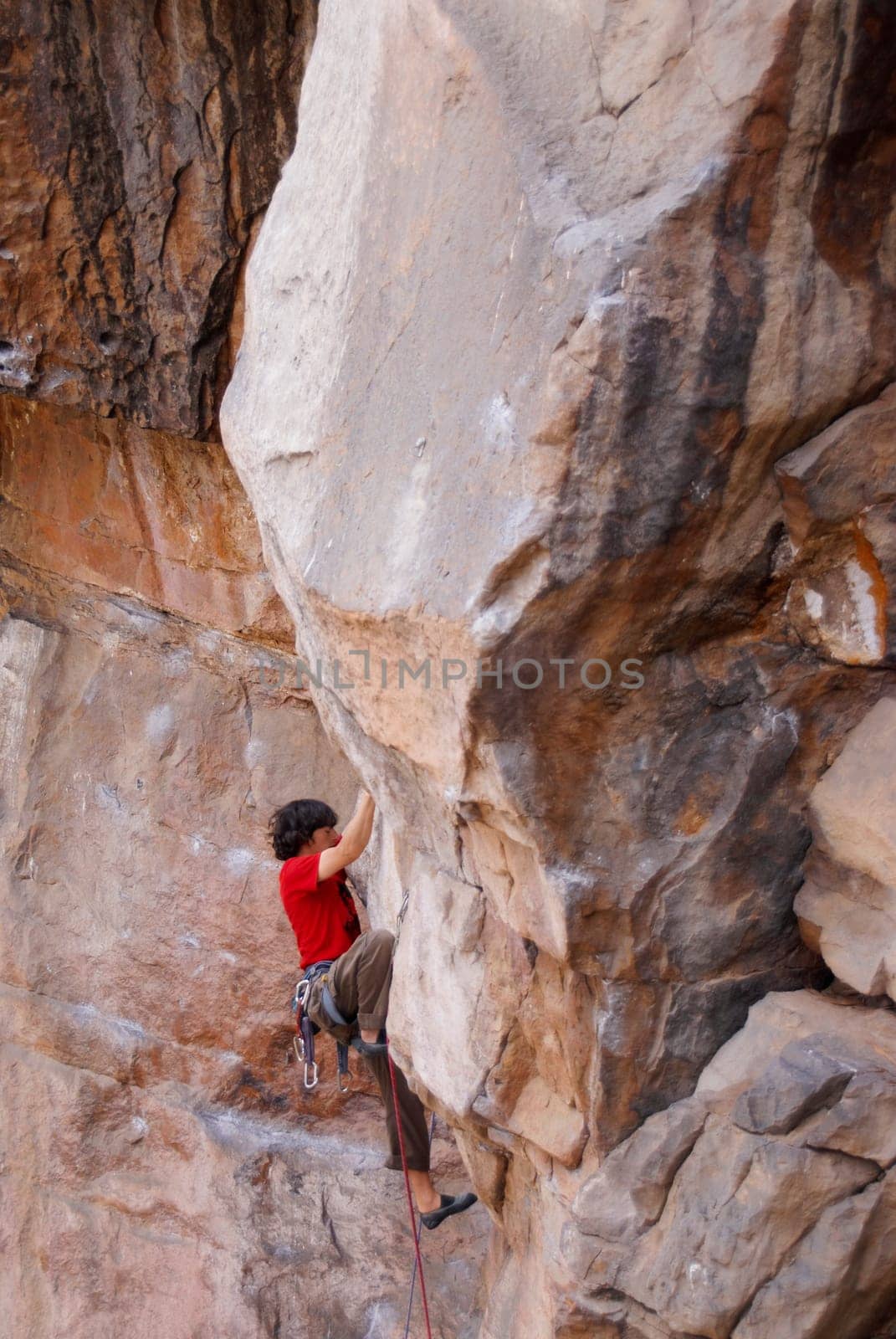 High angle view of a male rock climber scaling a rock face