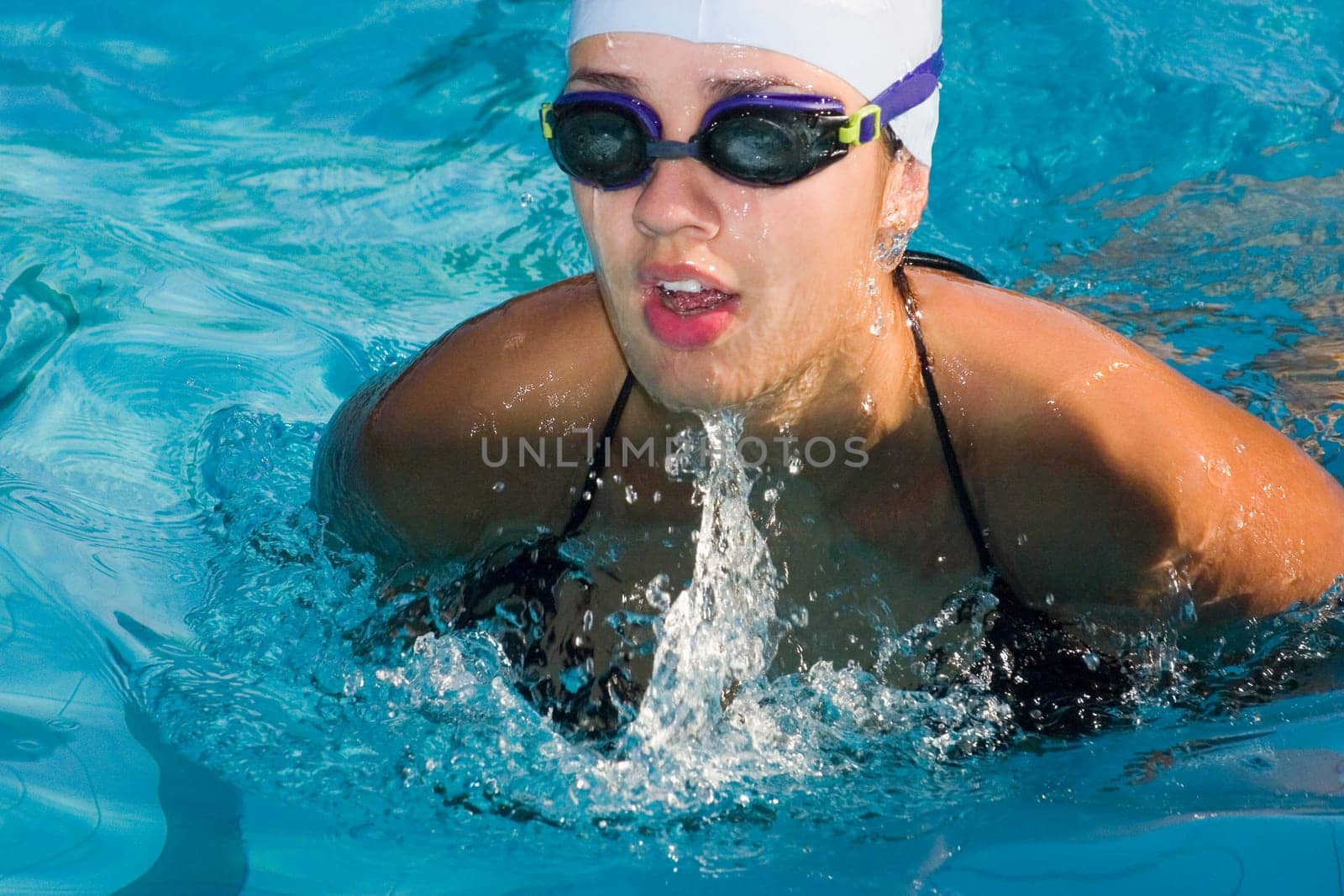 Close-up of a young woman swimming in a swimming pool