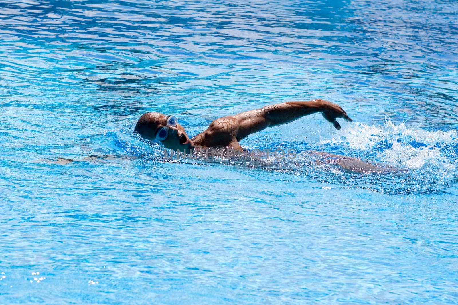 Mid adult man swimming in a swimming pool