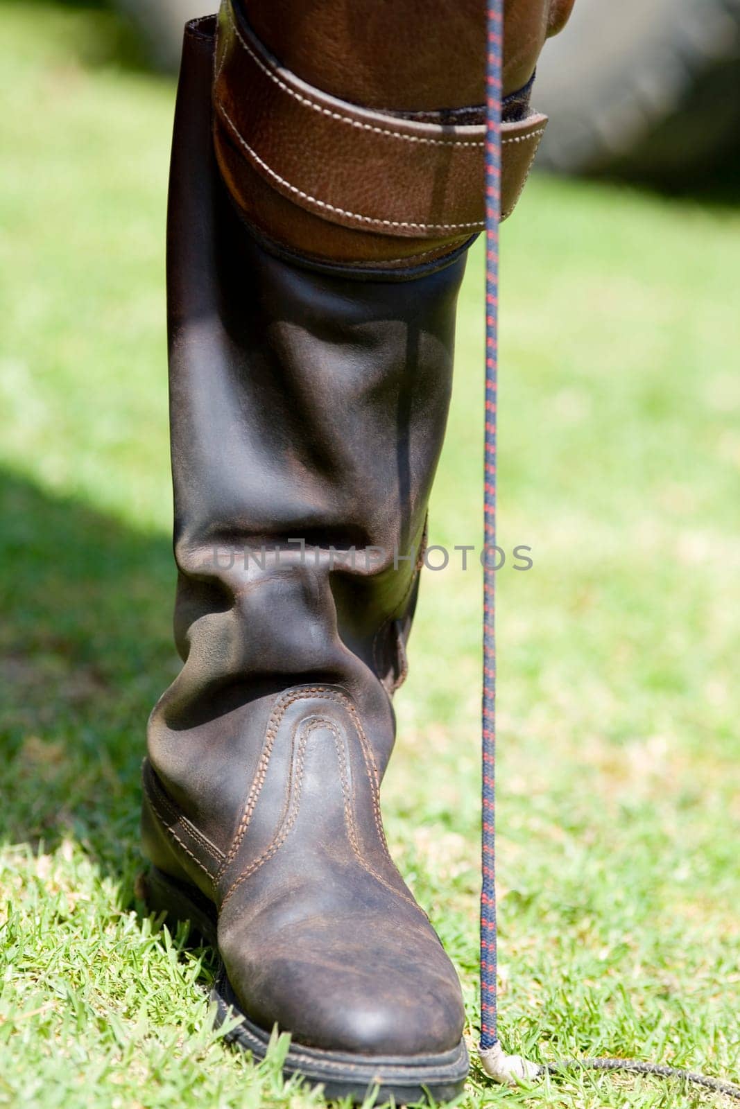 Close-up of a personŽs leg wearing a riding boot