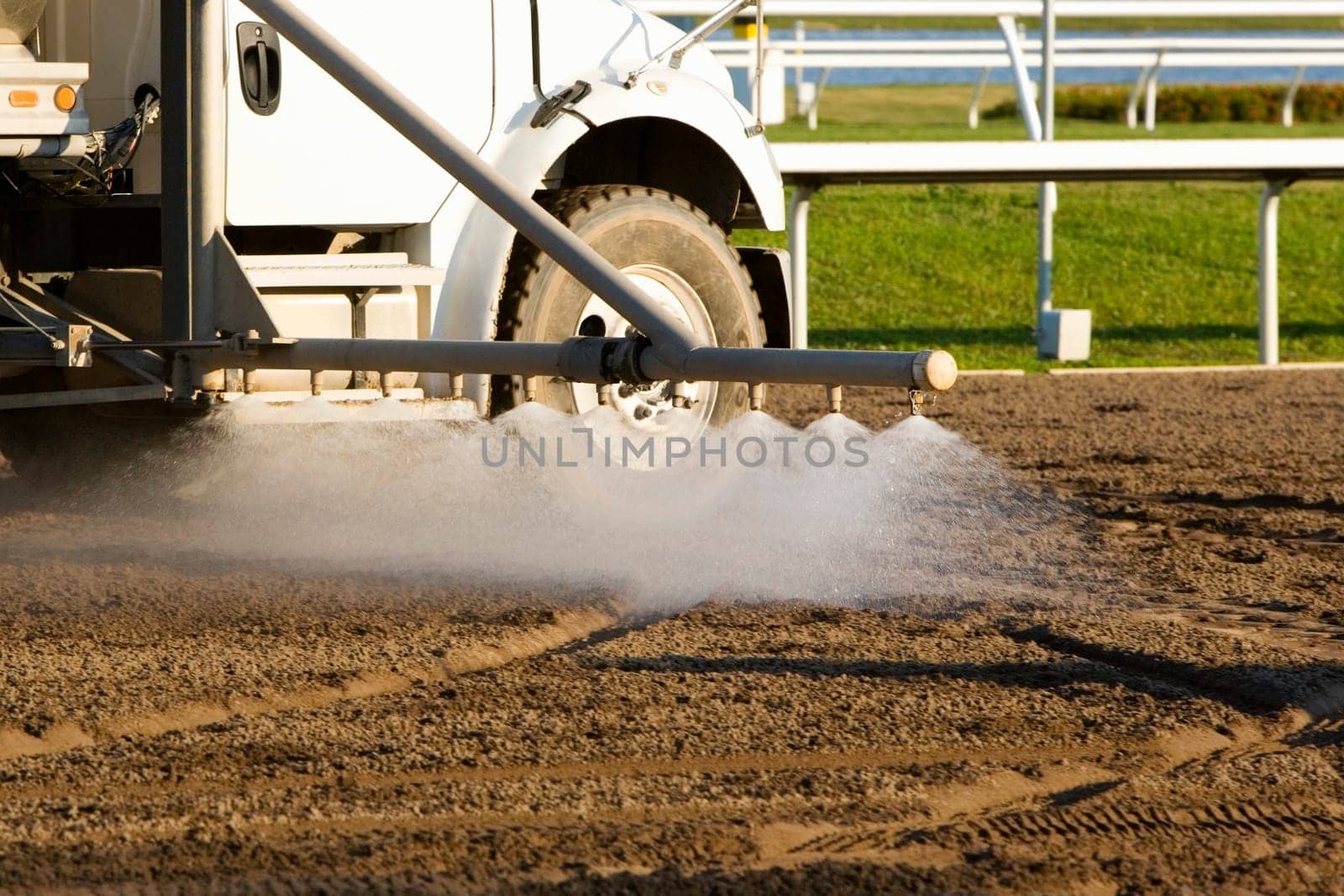 Truck spraying water on a horseracing track