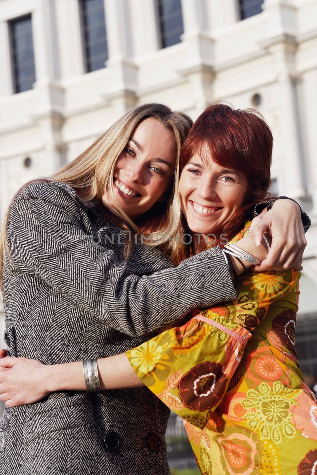 Portrait of two young women hugging each other