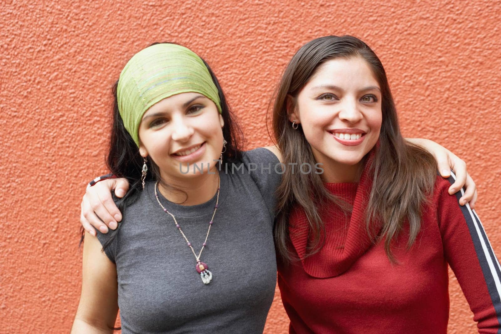 Portrait of two young women with their arms around each other