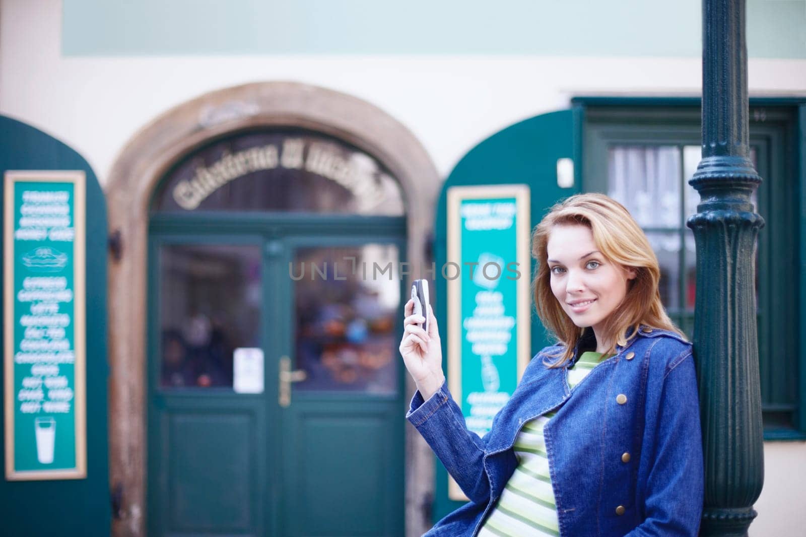 Portrait of a young woman holding a mobile phone